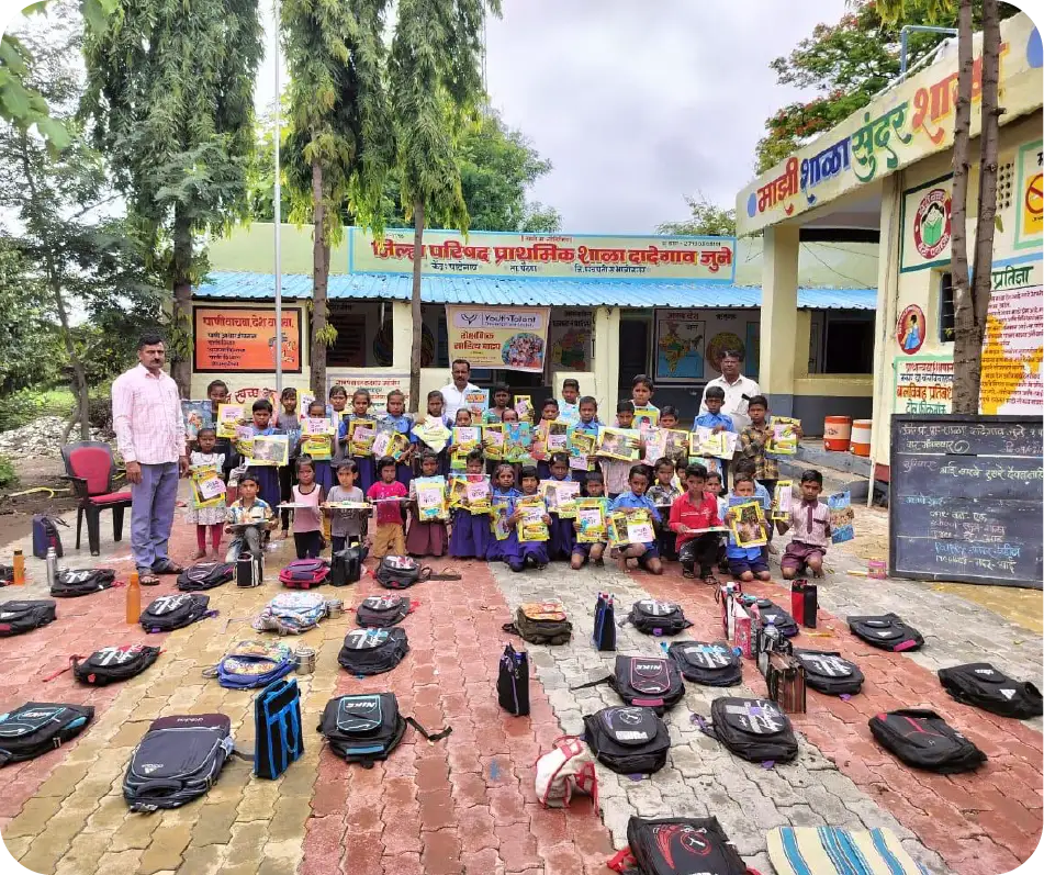Students receiving books and school kits as part of an education and digital literacy initiative